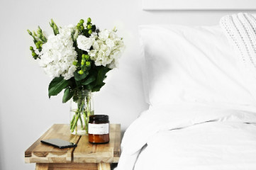 Serene Bed and Pillow with flowers on a nightstand 