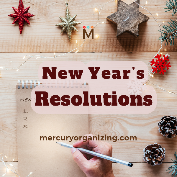 Image of hand writing New Year's Resolutions with Text over image of desk and colorful holiday ornaments